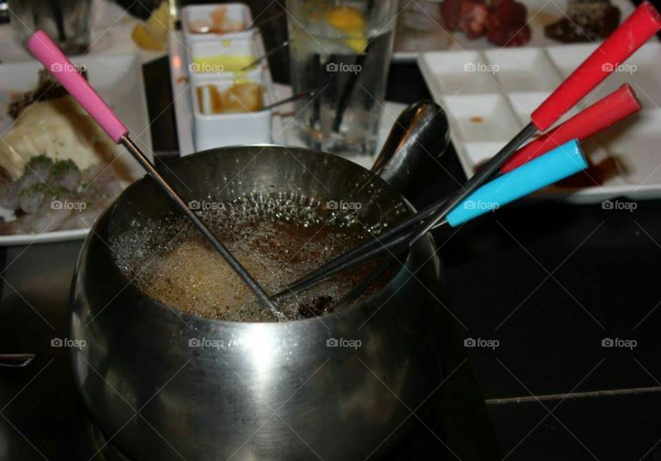 Cooking in oil at a fondue restaurant.