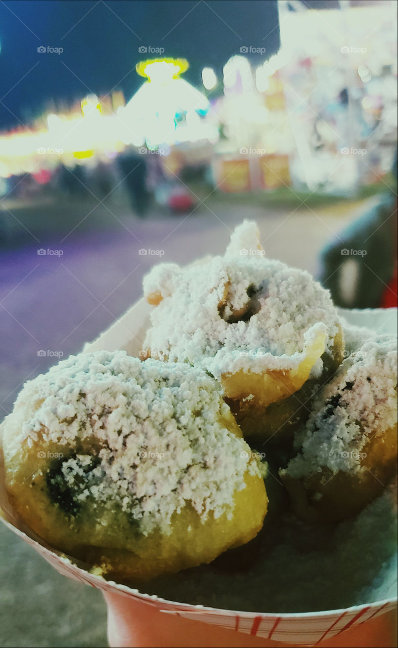 Deep fried Reese's Peanutbutter Cups. Overly sweet. Not Healthy. Rare treat! Gooden brown cake batter sprinkled with powder sugar. Fair Food!