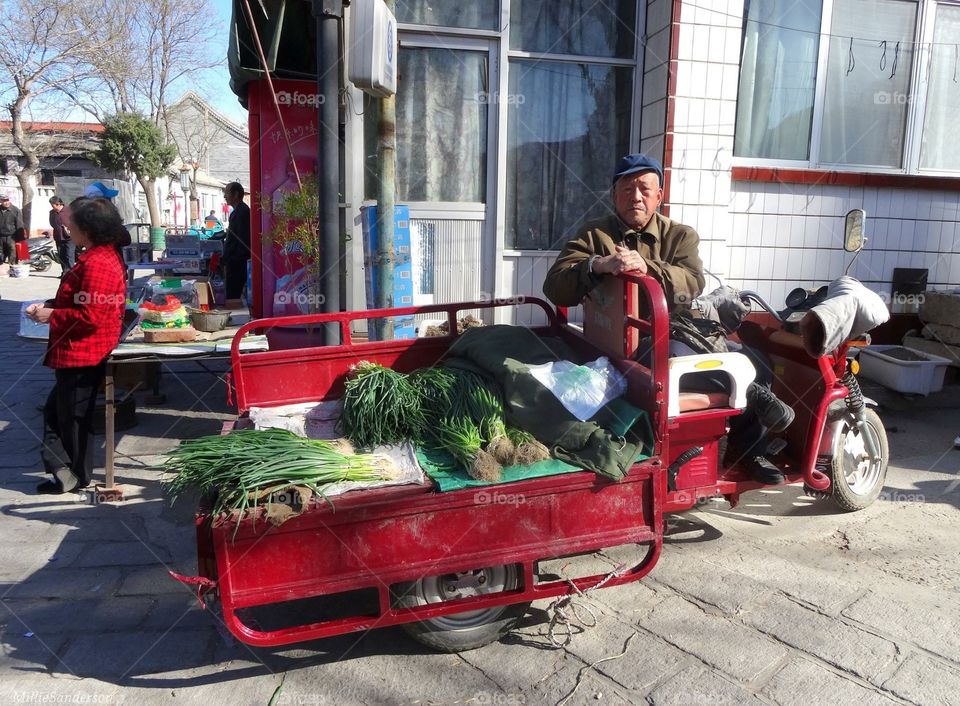 Man selling produce at Chinese street market 