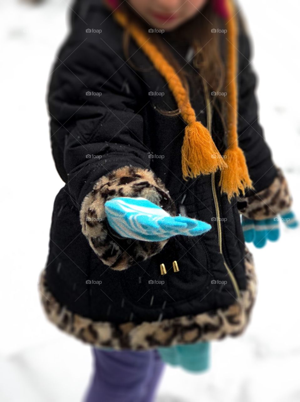 Little Girl catching Snowflakes in her hand