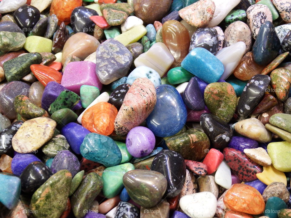 Colorful polished stones on display.