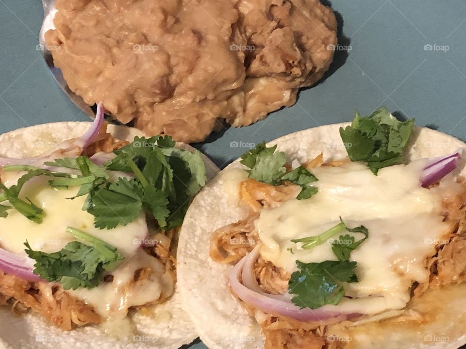 Chicken tostadas and refried beans with cheese