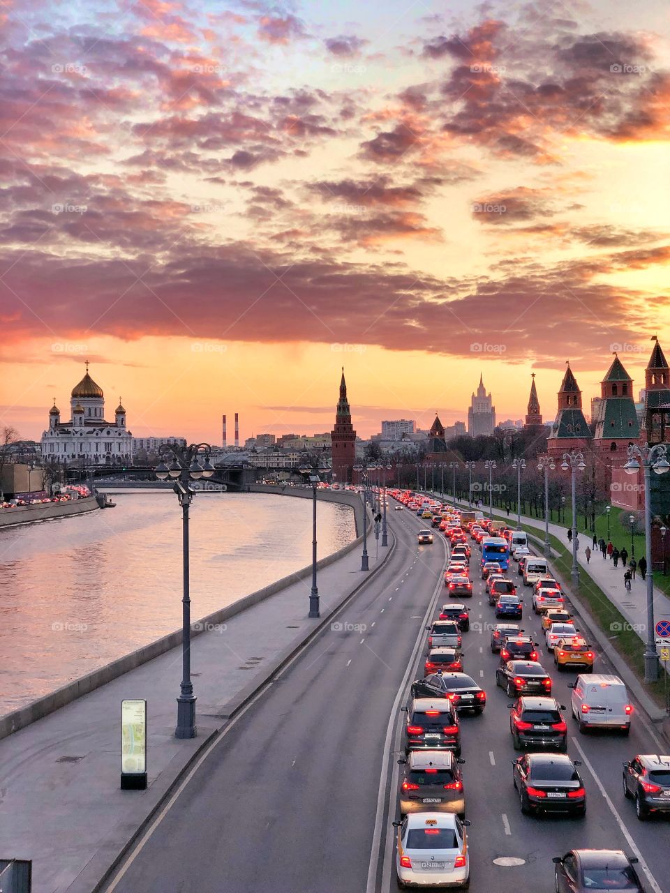 Sunset over the embankment of a big city