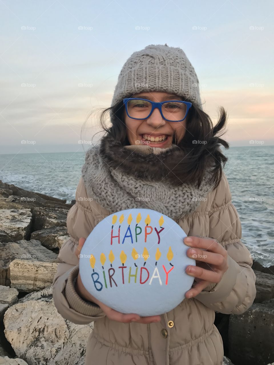Girl holding balloon with happy birthday text