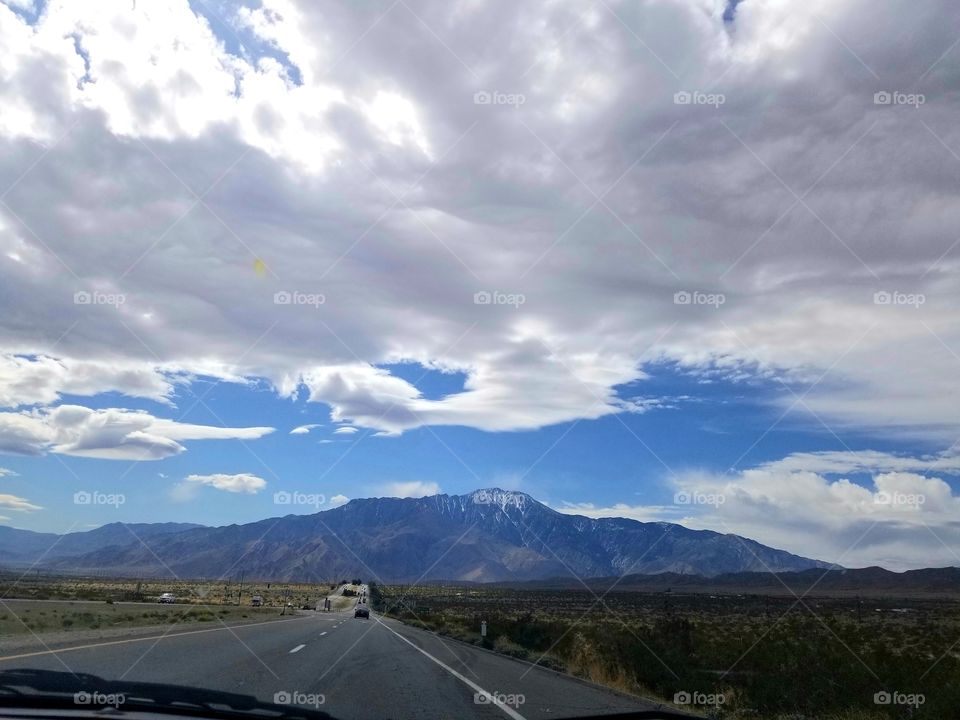 Road Trip IV: desert highway with mountains, clouds, and open space