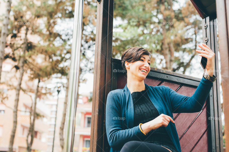 short air beautiful woman taking selfie smiling outdoors - connection, happiness