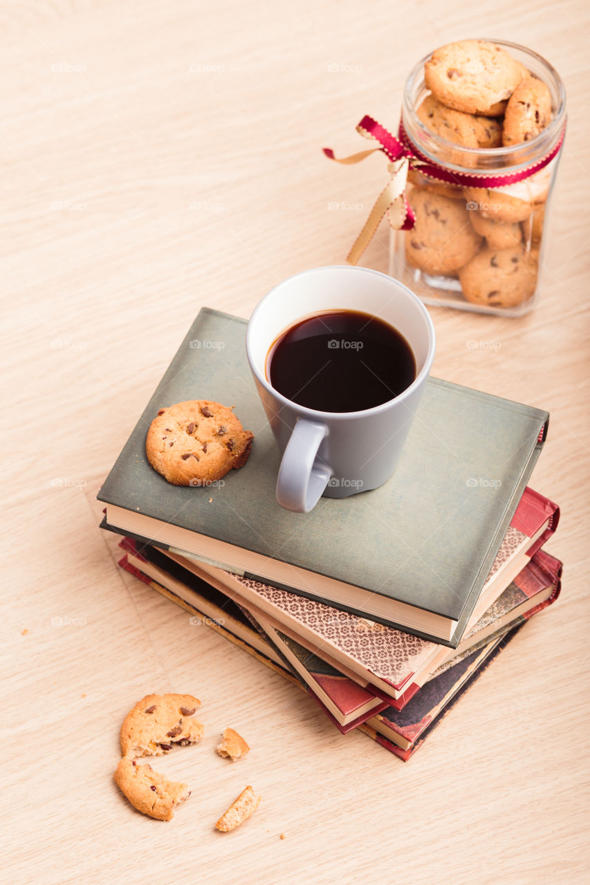 A few books with cup of coffee and cookies on wooden floor. Time for relax. Spending leisure time on reading. Cozy and comfortable. Relaxing π