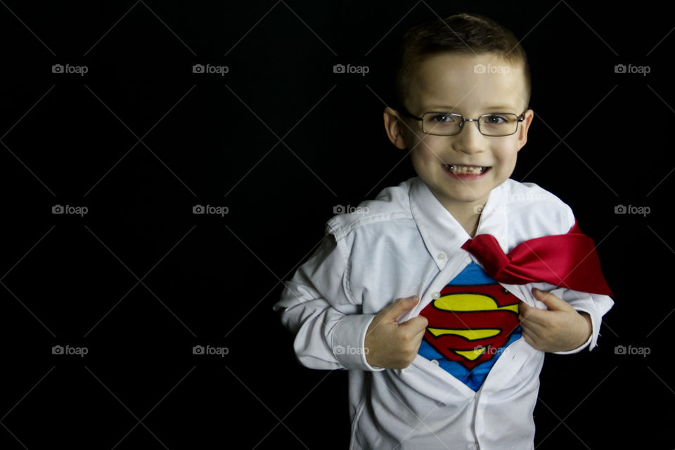 Boy showing superman symbol