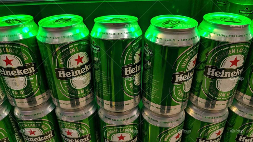 Heineken beer cans in green light
