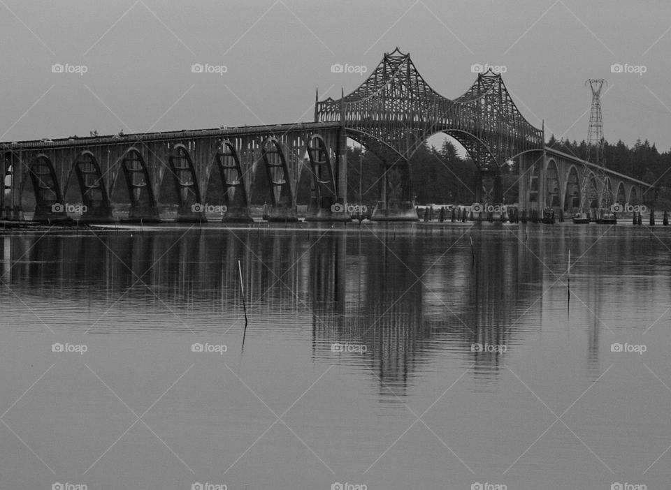 A steel bridge spans an Oregon coastal river as it nears the Pacific Ocean. 