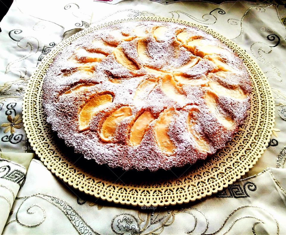 A homemade apple pie on a white tablecloth
