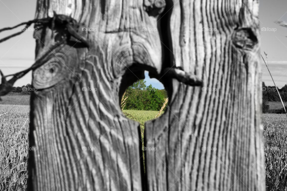 Hole through fence post