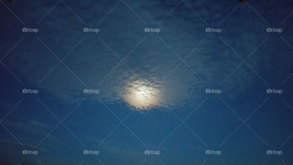 moon glowing through the clouds