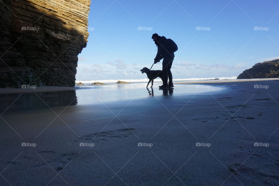 Beach#ocean#sky#rock#human#dog#sand