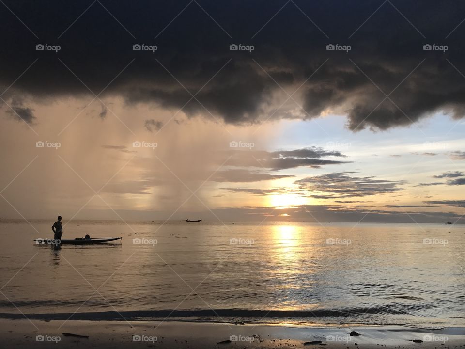 Golden hour in Koh Tao, Thailand. A beautiful colourful sunset, you can feel the peace and the local customs. Small boats.