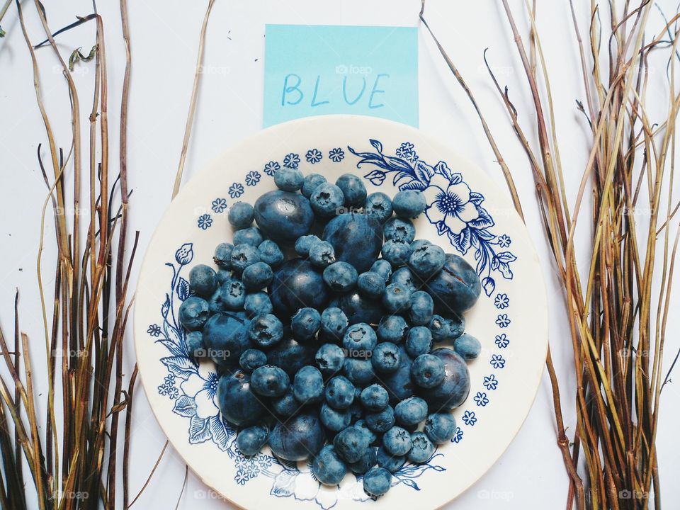 blueberries and plums on a plate