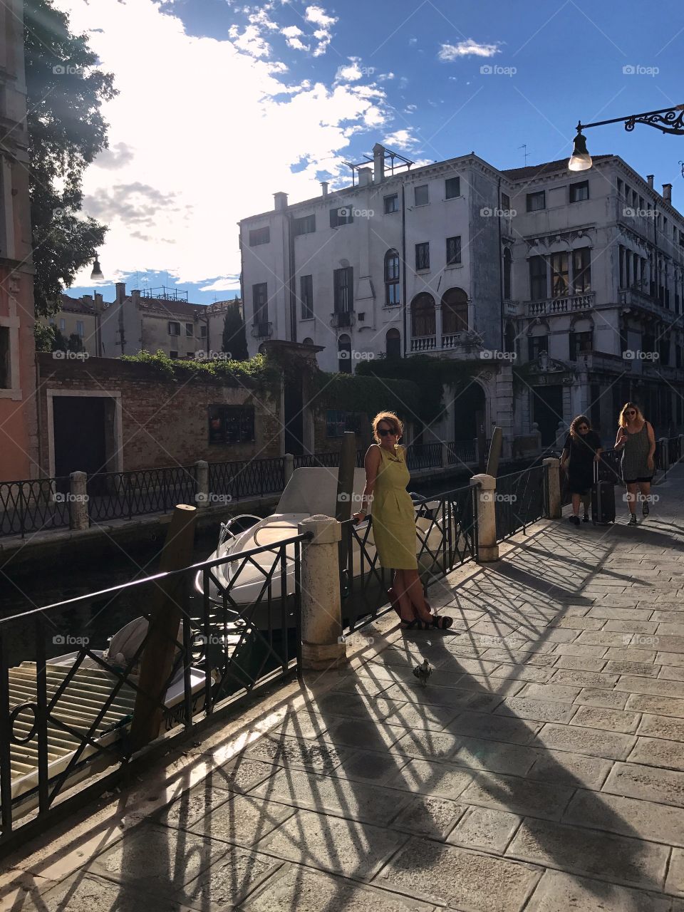 Woman leaning on canal railing