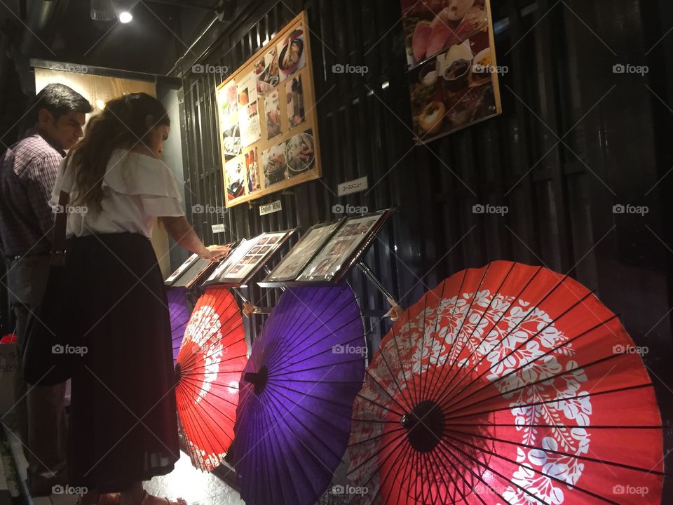 Visitors decide what to eat for dinner outside a traditional restaurant along this ancient food alley.