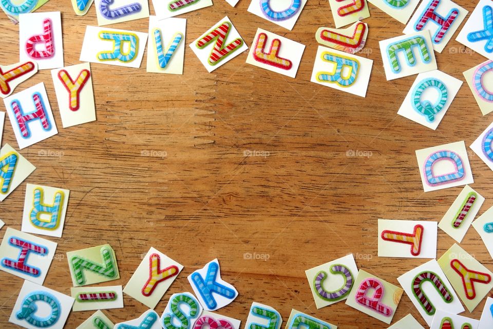 colorful letters as background. colorful letters on a wooden table as texture or pattern or background