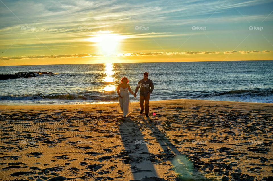 Couple walking on sandy beach