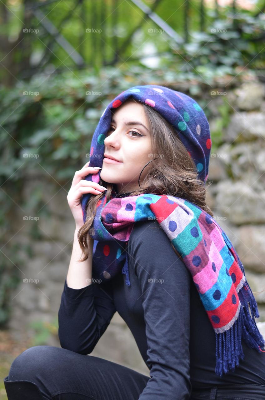 Portrait of a woman brunette with polka dot scarf