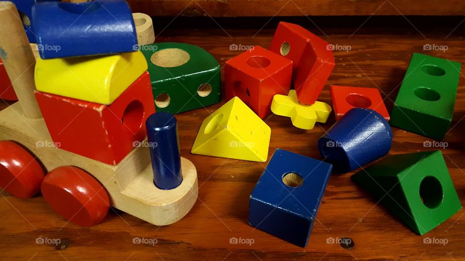 A wooden puzzle toy train in pieces.