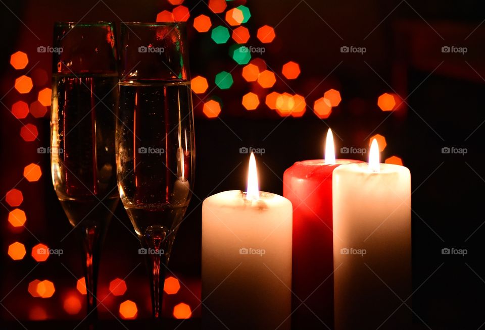 Champagne glasses and candles on bokeh background during new year celebration in gdynia, poland