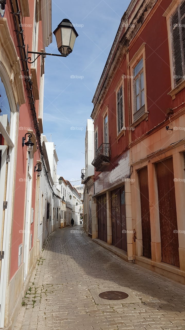 A beautiful street in Loule, Portugal. A beautiful colour on the walls of the houses welcomes you to Portugal.