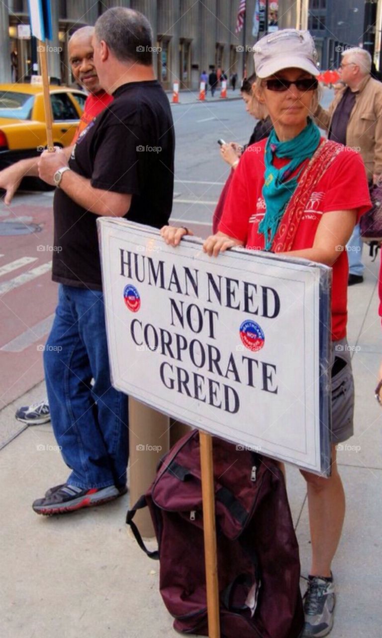 Human need not corporate greed. Protester at a rally in Chicago during the big banking scandals.
