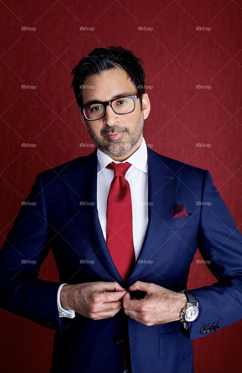 Portrait of stylish man in suit with red tie 