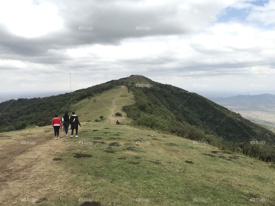 mountain environment landscape Cloud sky ridge leisure activity Nature Hiking activity scenics - nature Adult beauty in Nature walking Travel adventure Land Holiday Grass plateau in Ngong, Kenya