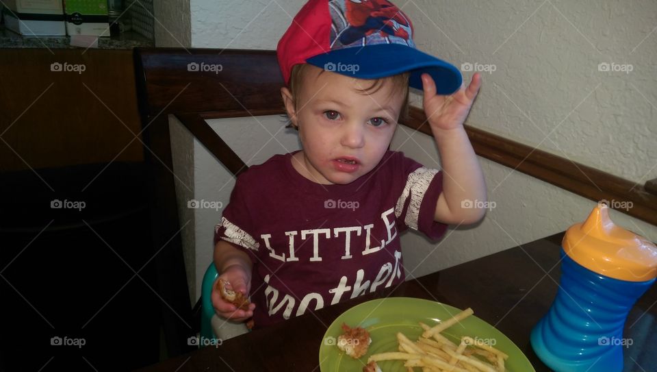 Cute little boy in ball cap.