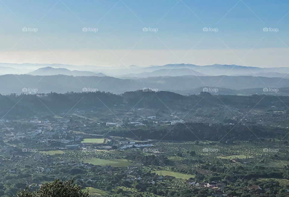 A view of Alvaiázere, from high up looking over the town to the cloud covered mountains in the distance.