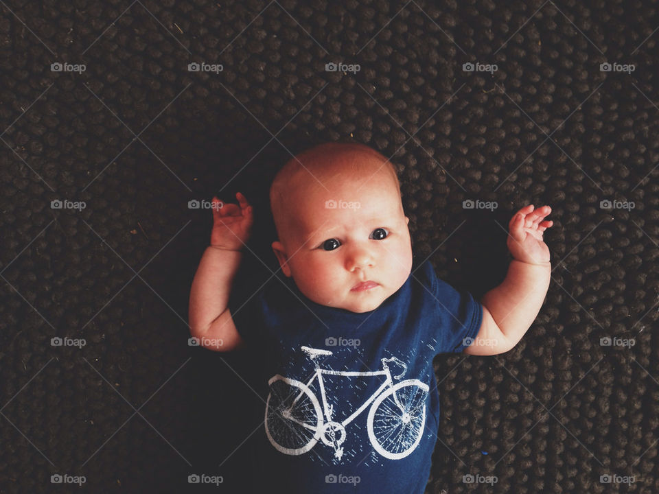Newborn Baby Wearing A Bicycle Onsie