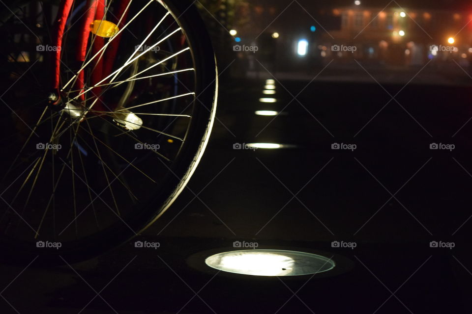 Lights Reflection Over Bike Wheel