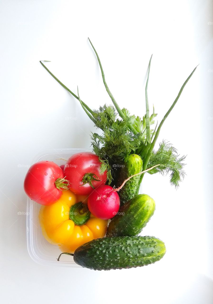 Vegetables and greens on a white background