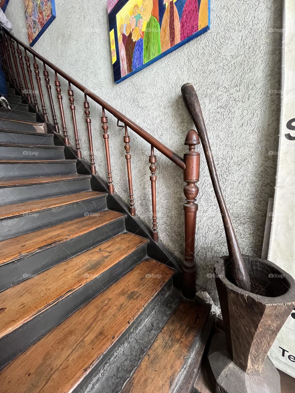 A handmill at the bottom of an old stair