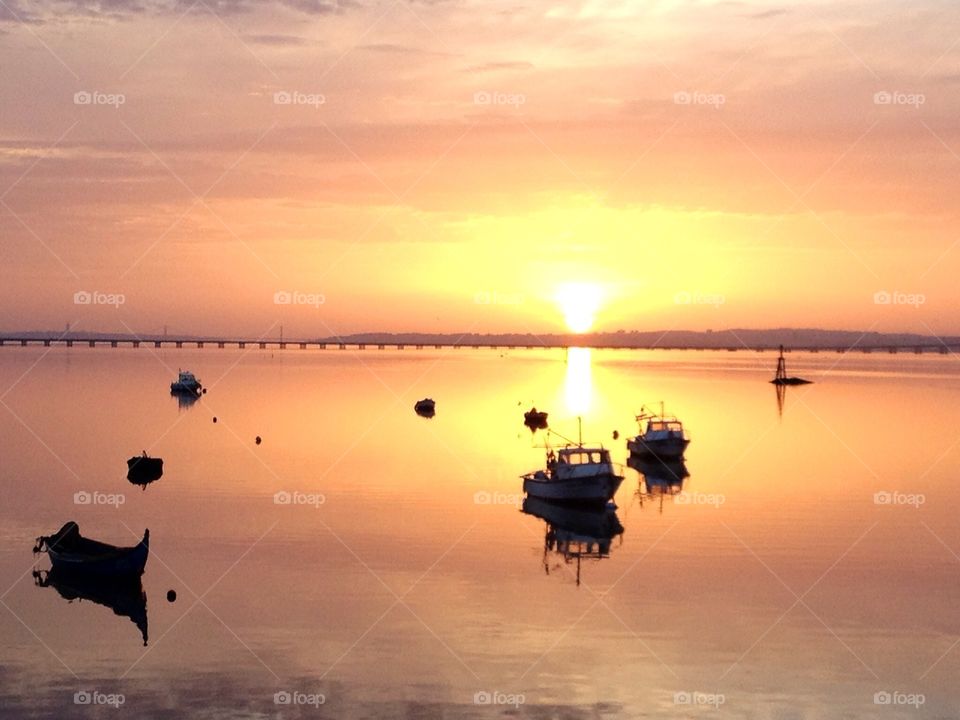 Boats, sunset and bridge

