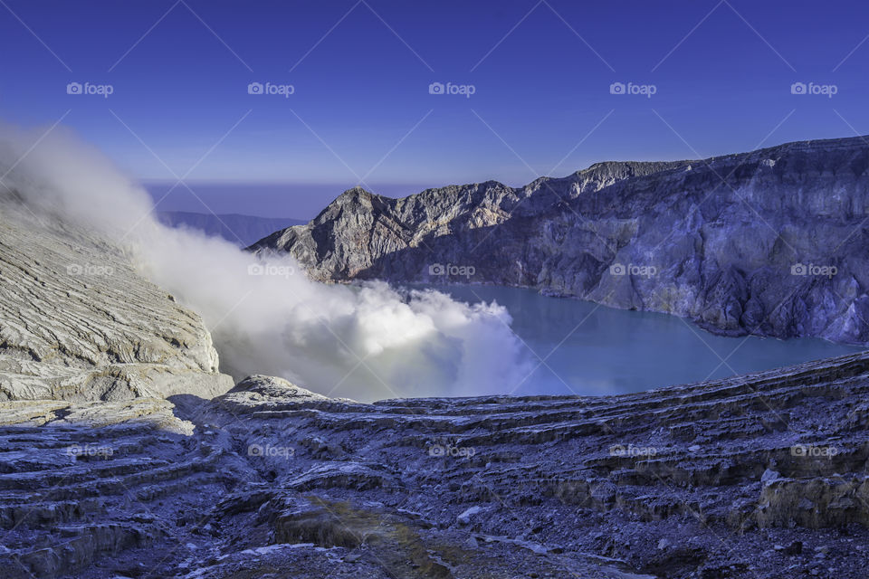 Acid Lake with Toxic Sulfur Smoke in Kawah Ijen Volcano Caldera