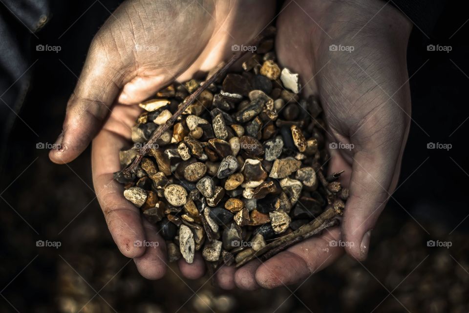 Overhead view of person hand holding stones