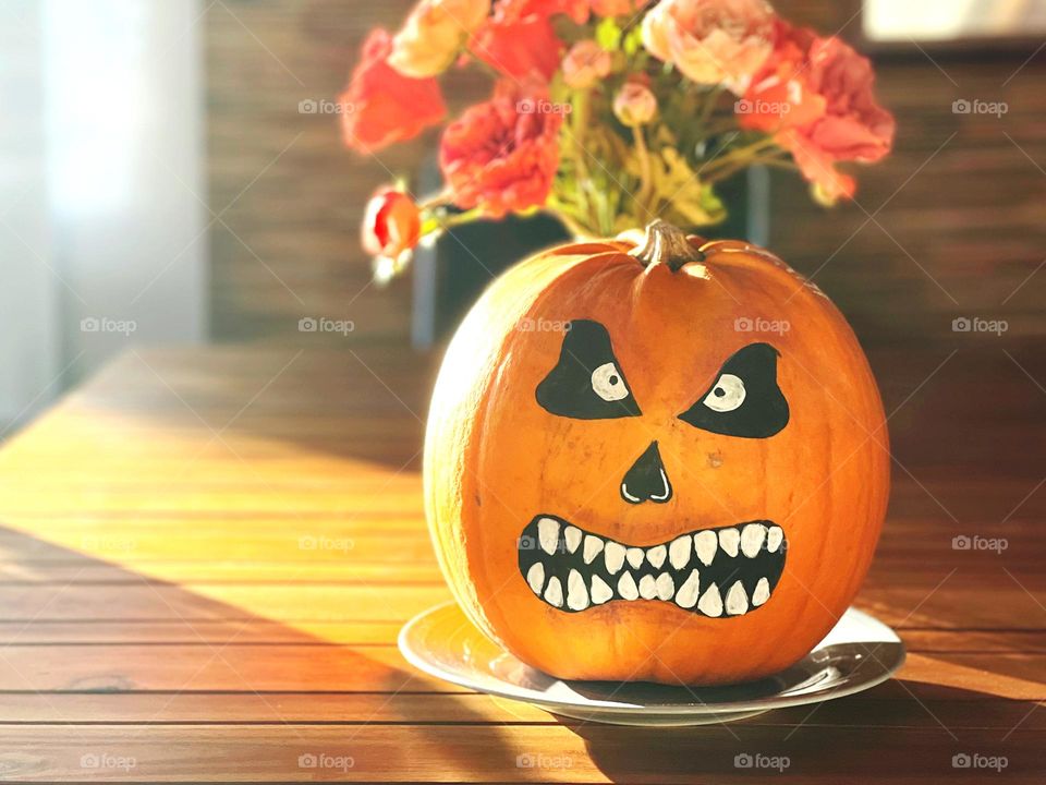 Beautiful decorated pumpkin on a table in the sun