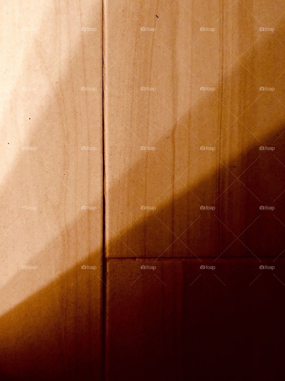 Gradient shadows on tile floor by doorway 