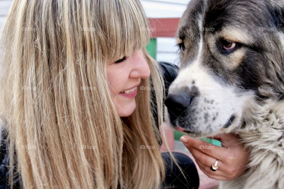 Beautiful long haired blonde with big dog. 