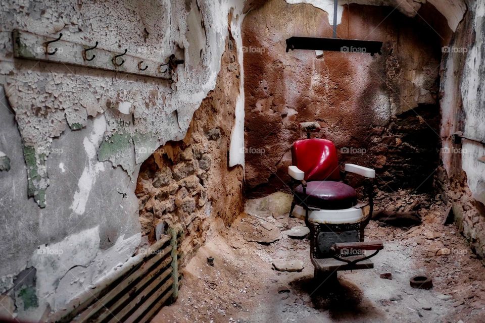 Creepy abandoned barbershop chair in a prison, abandoned buildings, scary abandoned prisons, frightful places that are abandoned, abandoned barbershop chair, Eastern State Penitentiary 