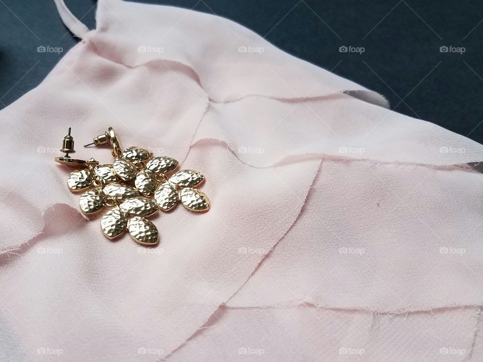 Shiny earrings on dress