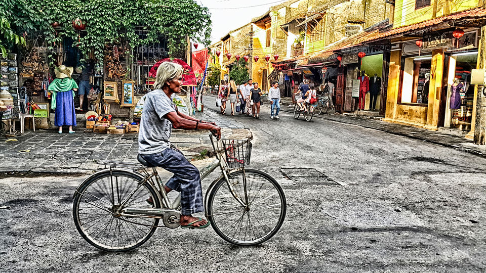 Me and my bicycle. old man riding a bicycle in hoi an Vietnam