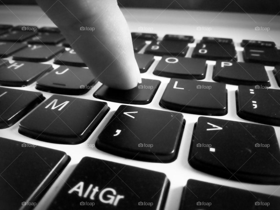 pressing a laptop key by finger