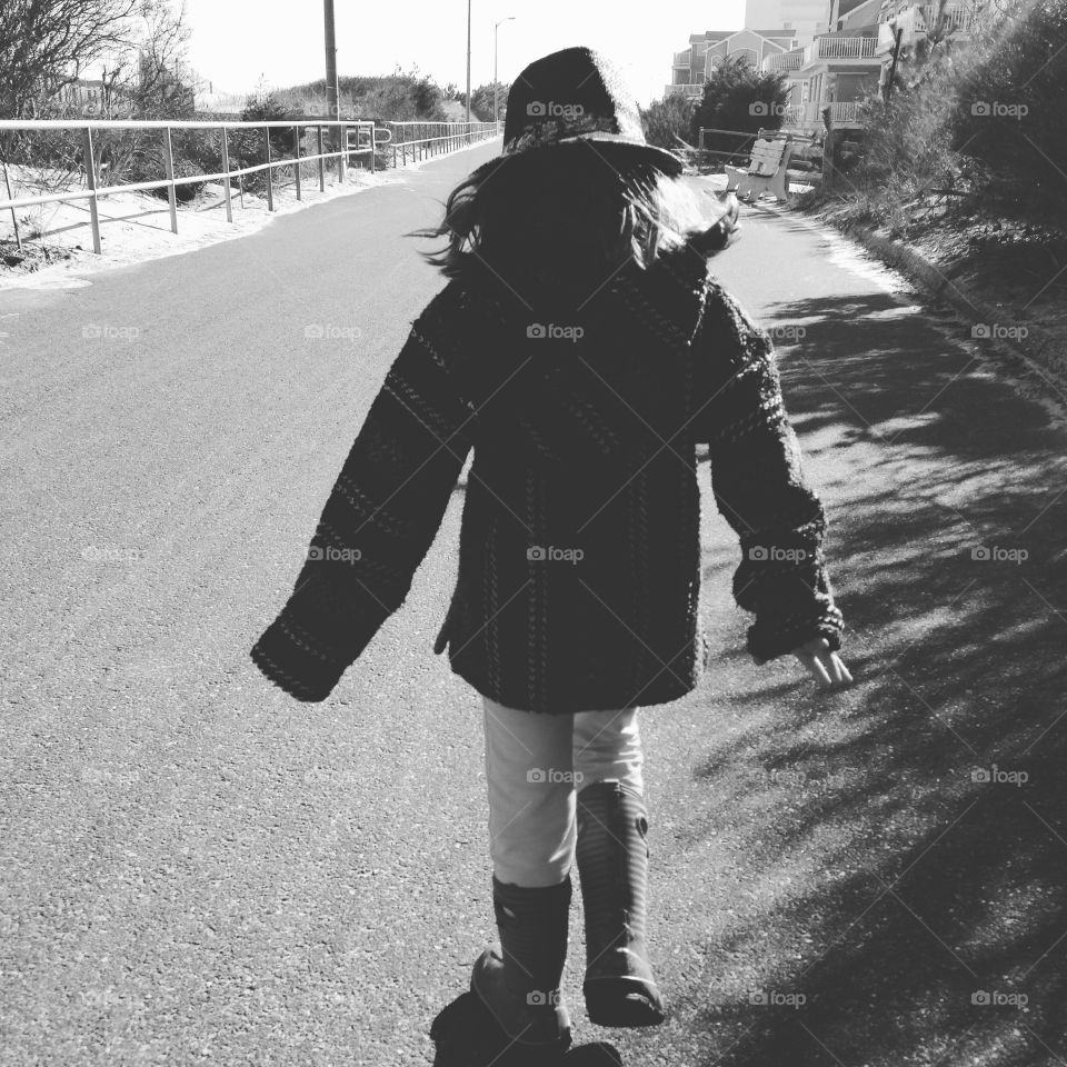 Peaceful walk . Taking a walk on the boardwalk is always better with company , Bradin is caught up in her thoughts and enjoying the day