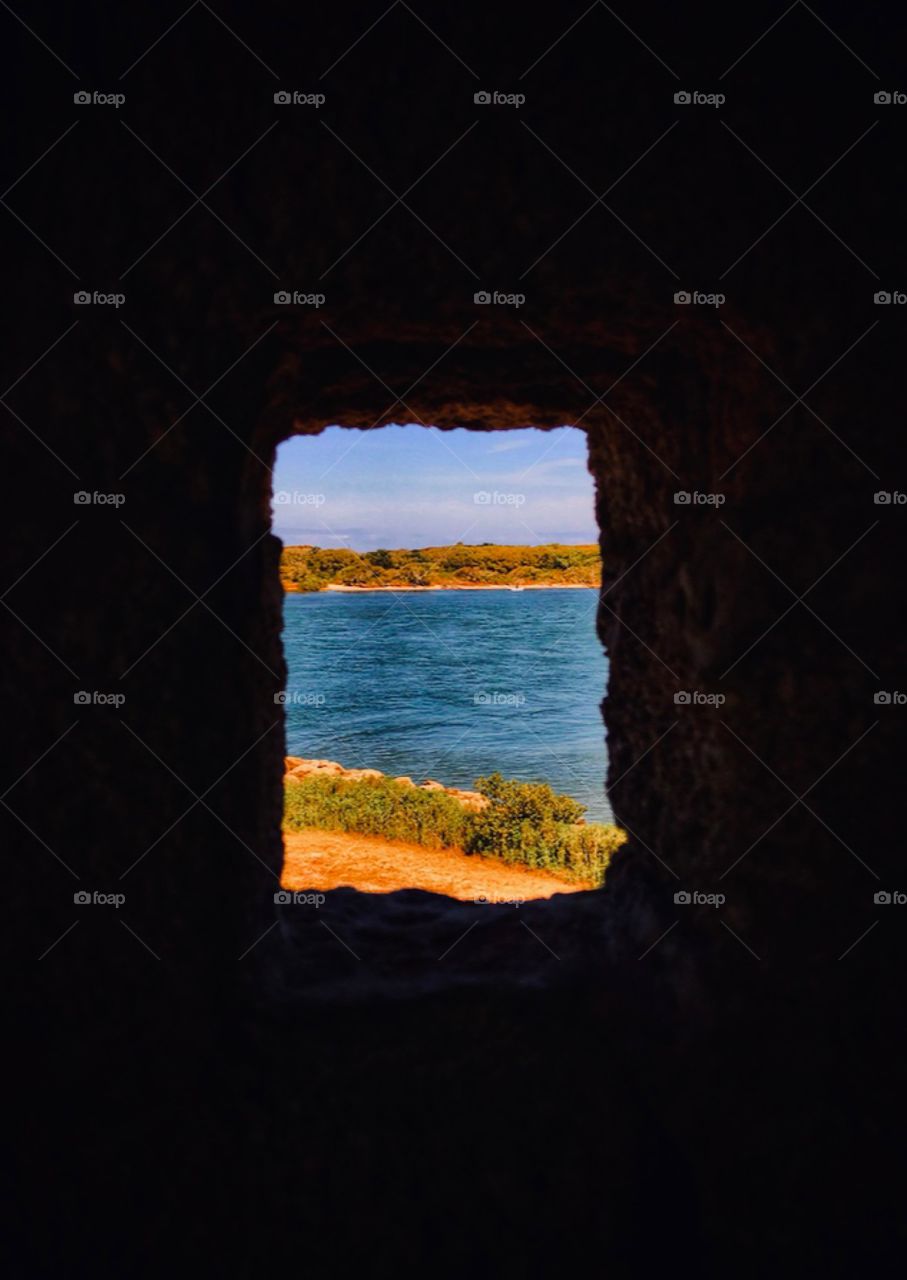 View of an inlet of the Atlantic Ocean through a guard tower of an old Spanish fort—taken in St. Augustine, Florida 