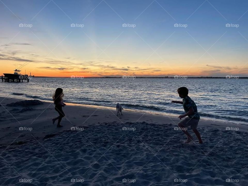 Kids Playing on Beach at Dusk